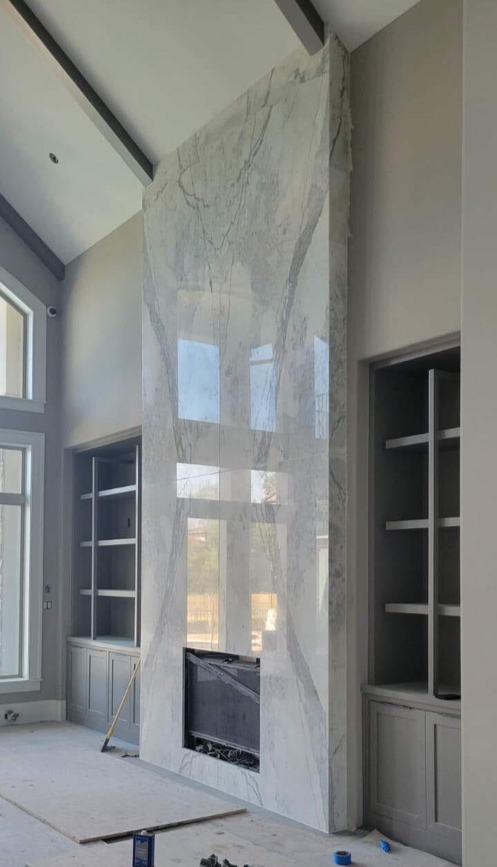 A wonderful stone fireplace, so smooth and beautiful it reflects the sunlit backyard off its surface.