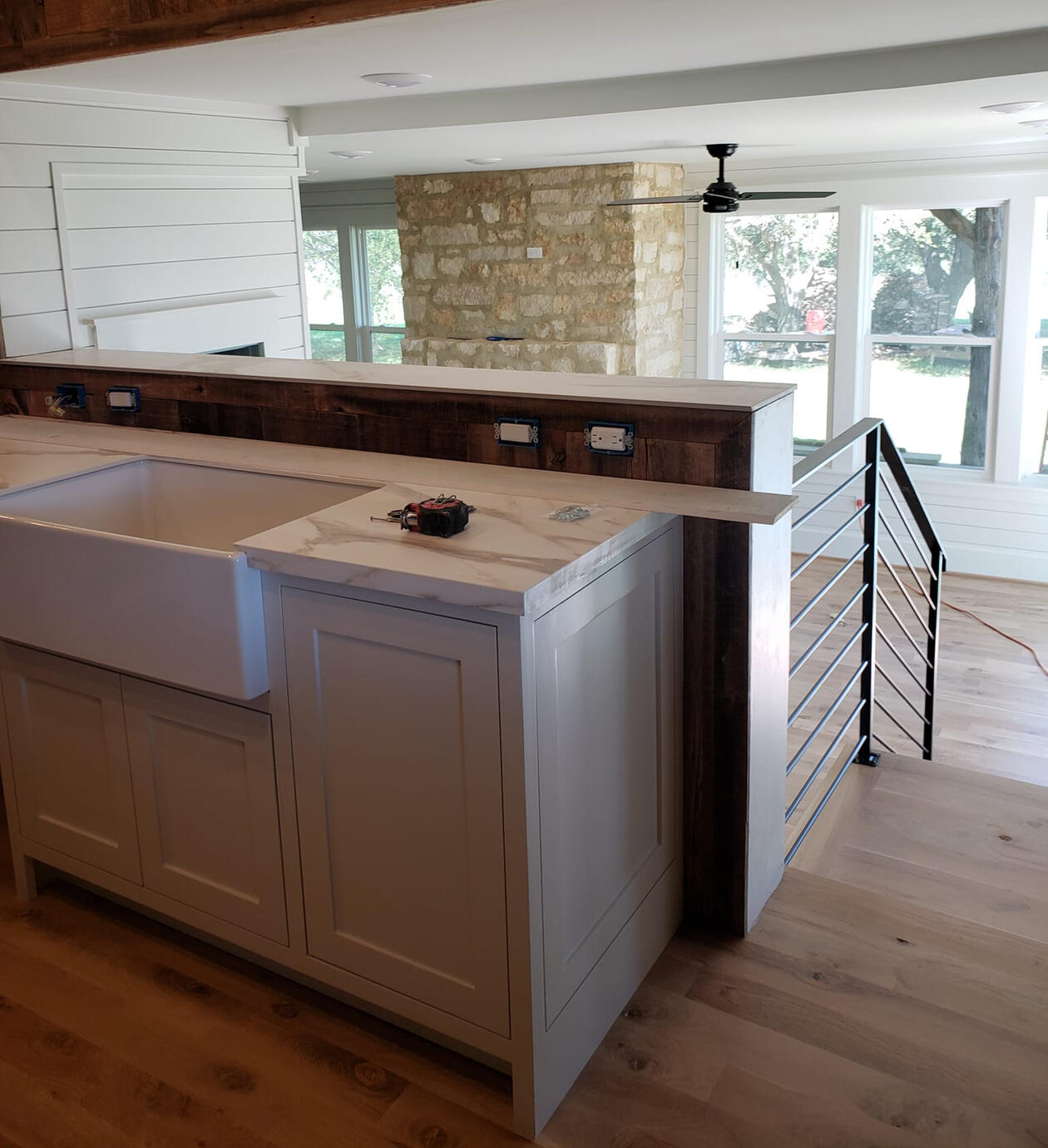 Counter top made with marbled granite that is in a small kitchen space