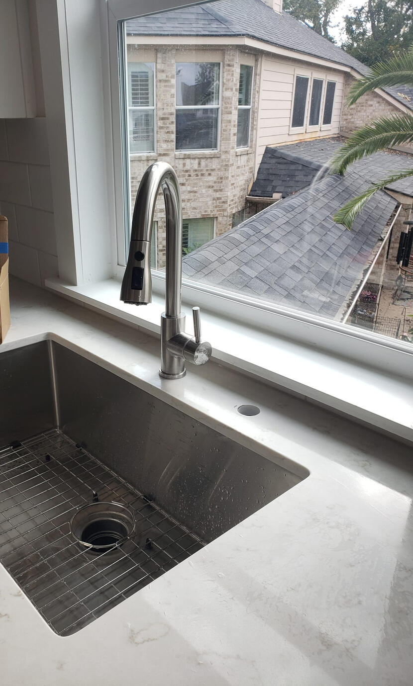 A close up shot of a new counter installation with beautiful contrast to the sink.